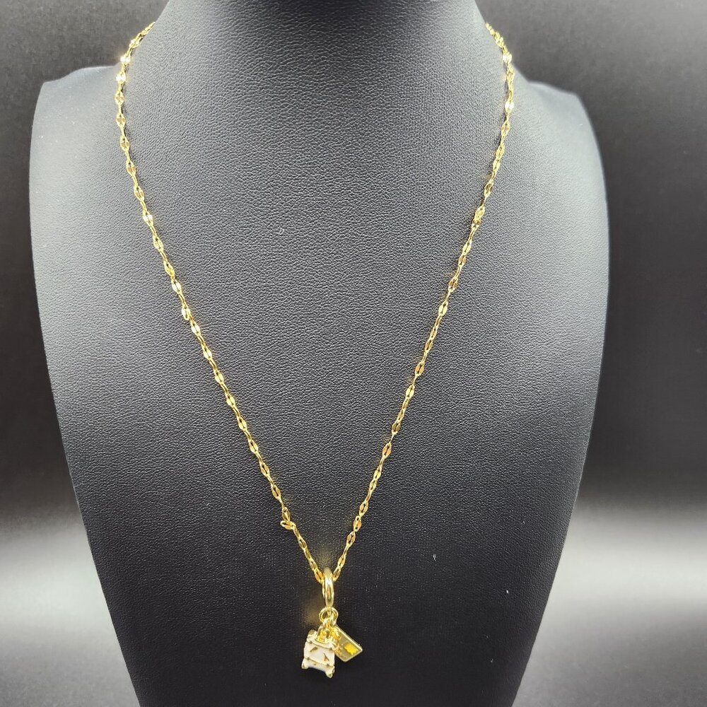 Gold plated travel themed necklace with suitcase and postcard charm